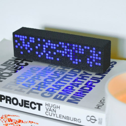 Blue Matrix Premium Habit Tracker - LEDs displaying Day Mode function on top of books